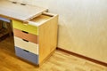 Plywood desk with multi color drawers during assembly