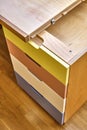 Plywood desk with multi color drawers during assembly. Close-up