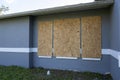 Plywood storm shutters for hurricane protection of house windows. Protective measures before natural disaster in Florida Royalty Free Stock Photo