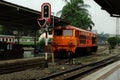 4.26pm, Hualamphong railway station, Bangkok, ThailandOrange Diesel Train moving to terminal station.