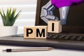 PMI - acronym from wooden blocks with letters, abbreviation PMI Private Mortgage Insurance Royalty Free Stock Photo