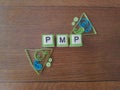 PMP letters with green and blue accent color on wood background Royalty Free Stock Photo