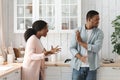 PMS Concept. Furious Young African American Woman Screaming At Husband In Kitchen Royalty Free Stock Photo