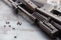 Pneumatic shooting.an air rifle and bullets on a steel table. A black air rifle lies against the background of steel in close - up Royalty Free Stock Photo