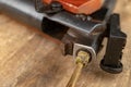 A pneumatic weapon on a wooden table on a shooting range. Shooting accessories needed for shooting sports