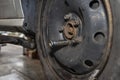 The pneumatic wrench cap attached to the screw on the steel car wheel after it has been replaced. Royalty Free Stock Photo