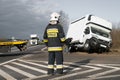 Firefighters at the accident scene with an overturned car in the background Royalty Free Stock Photo