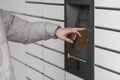 Shopping locker inPost with man& x27;s hand entering code to open it. Caption: Read the QR code here and pick it up Royalty Free Stock Photo