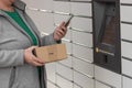 Old woman with smartphone entering code to open shopping locker. Caption: Read the QR code here and pick it up faster. Royalty Free Stock Photo