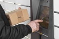 Shopping locker inPost with old man hand entering code to open it. Caption: Read the QR code here and pick it up faster. Royalty Free Stock Photo