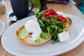 Poach eggs with arugula and dried tomato salad