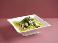 Poached Chinese Spinach with Egg Trio and Minced Pork with chopsticks served in a dish isolated on mat side view on grey