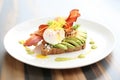 poached egg avocado toast with bacon strips on white plate Royalty Free Stock Photo