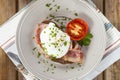 Poached egg and bacon on rye bread, healthy breakfast