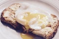 Poached egg on brown toast Royalty Free Stock Photo
