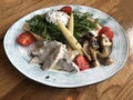 Poached egg on sourdough toast, with tomatoes, mushrooms, salad leaves, ears of corn and braised chicken Royalty Free Stock Photo