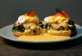 Poached egg with spinach, mushrooms topping with red caviar on burger. Wooden cutting board