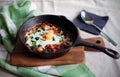 Poached egg in tomato sauce and spices, traditional arabic shakshouka