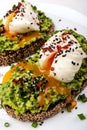 Poached eggs with avocado guacomole on brown bread with sesame seeds. Healthy breakfast on a white background. Royalty Free Stock Photo