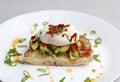 Poached eggs bacon tomatoes avocado on toast Royalty Free Stock Photo