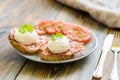 Poached eggs served on toast with bacon and tomato and herbs Royalty Free Stock Photo