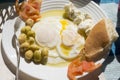 Poached fried eggs with goat`s cheese, tomatoes and olives, Moroccan breakfast