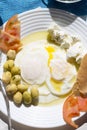 Poached fried eggs with goat`s cheese, tomatoes and olives, Moroccan breakfast