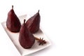 Poached pears in red wine isolated on white background. Royalty Free Stock Photo