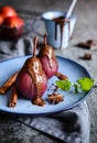 Poached pears in red wine and topped with chocolate sauce Royalty Free Stock Photo