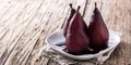 Poached pears in red wine on wooden table Royalty Free Stock Photo