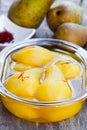 Poached pears with spices in syrup on the glass bowl Royalty Free Stock Photo