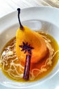 Poached pears with spices in syrup on the white plate. Delicious Royalty Free Stock Photo