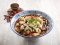 Poached Sliced Fish in Szechuan Style with chopsticks served in a dish isolated on mat side view on grey background