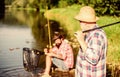 Poaching crime and fishing license. Extracts eggs from sturgeon caught river. Trap for fish. Men sit at riverside with Royalty Free Stock Photo