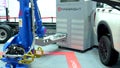 Pobotic arm Yaskawa Legend Firebright automatically replaces loads unloads charged lithium ion batteries in an electric