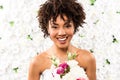 African american bride looking at camera while holding flowers Royalty Free Stock Photo