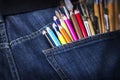 Pocket with brushes and pencils Royalty Free Stock Photo