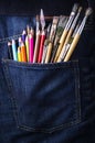 Pocket with brushes and pencils Royalty Free Stock Photo