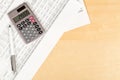 Pocket calculator with pen on financial analysis sheet background on wooden office desk - tax, finance or accounting concept Royalty Free Stock Photo