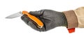 Pocket folding knife with bright orange handle in palm of male hand in black protective glove and brown uniform isolated on white Royalty Free Stock Photo