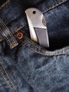Pocket knife in jeans pocket Royalty Free Stock Photo