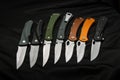 Pocket penknives. A variety of folding knives on a dark back
