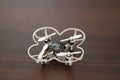 Pocket quadcopter with white petals on a table