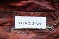 In the pocket of a red leather jacket under the zipper is a leaflet with the text trends 2021