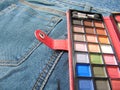 Pocket travel makeup palette on jeans Royalty Free Stock Photo
