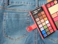 Pocket travel makeup palette on jeans Royalty Free Stock Photo