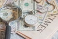 Pocket watch, American dollars and a magnifying glass Royalty Free Stock Photo