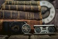 Pocket watch, blur stack of old book, hourglass, vintage binocular and world desk globe on dark background. Journey and Royalty Free Stock Photo