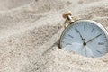Pocket watch buried in sand Royalty Free Stock Photo