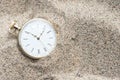Pocket watch buried in sand Royalty Free Stock Photo